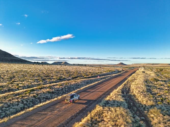 Gondwana Collection Namibia specialized 4x4 expedition vehicle on a remote desert road, demonstrating the company's high-end logistical capacity and destination management for international B2B partners.